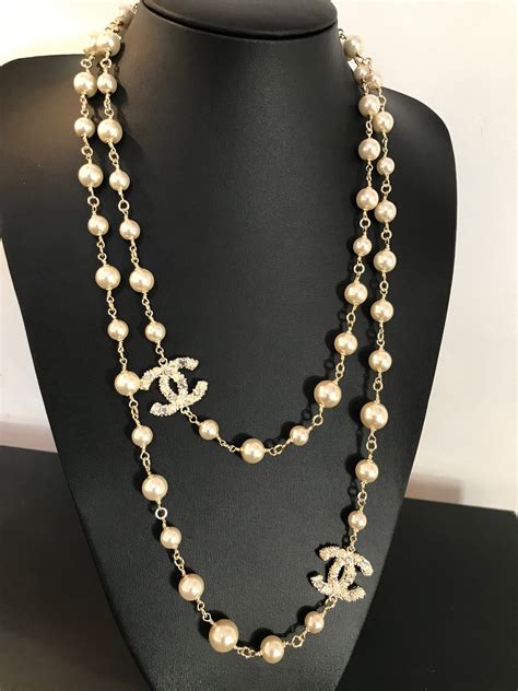 chanel logo necklace gold plated|Chanel long pearl logo necklace.